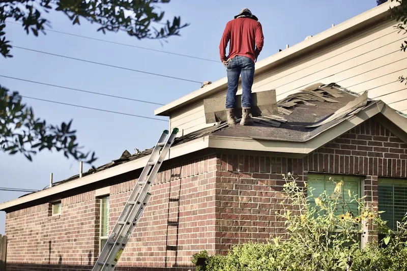 Professional roofer working on a residential roof in Donald
